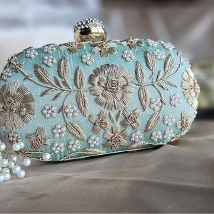 Beautiful hand embroidered oval clutch.